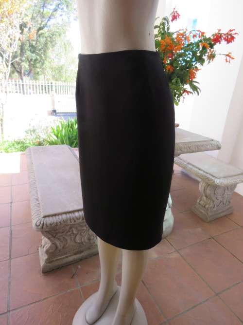 Black fully lined pencil skirt with zip and pleat at back.Size 42/18 by 'MERIEN HALL'.As new.