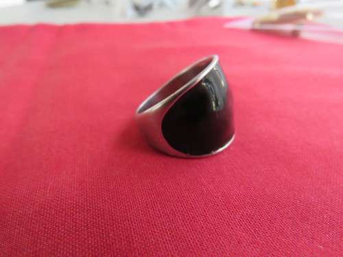 Silver toned ring with black top. Size 9.New.