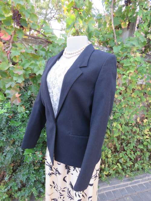 Elegant black wool blend fully lined jacket in size 32/8.Two pockets at front.As new.