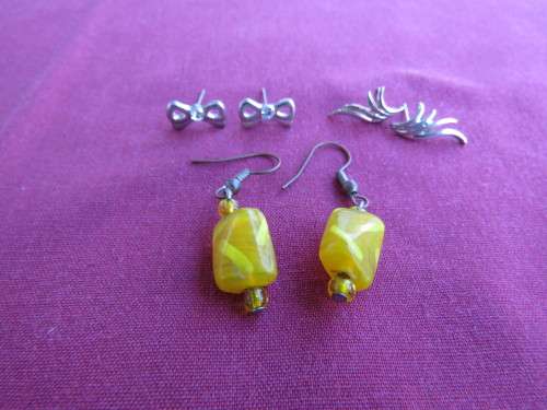Three sets of piercing earrings:yellow beads/tiny silver toned bows/tiny silver wings.All as new.