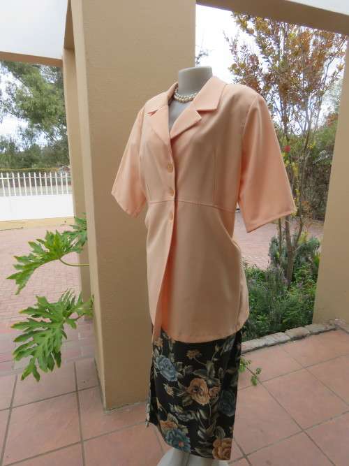 Smart peach colour short sleeve jacket in 100% polyester.Size 40/16 by `G.A.R.B`.New condition.