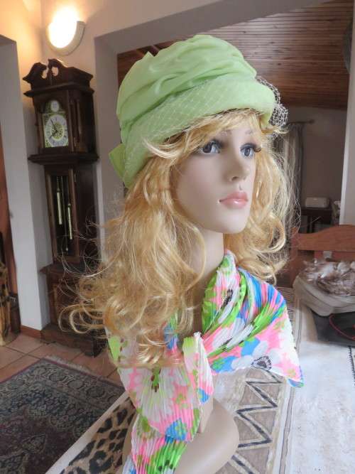 Ladies occasion hat in green organza with netting on front and bow at back.As new.