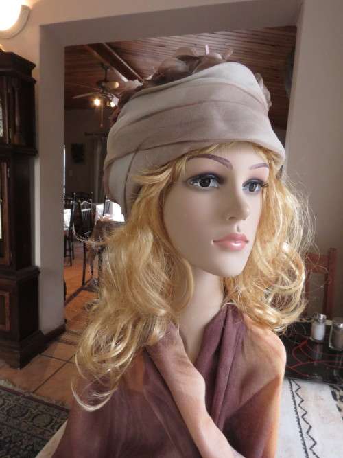 Ladies special occasion hat in different beige/brown colours.In folded organza with flowers.