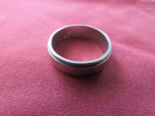 Men`s silver toned wedding ring in size 9.5.As new.