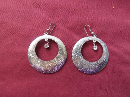 Pair of round piercing earrings with hanging faux diamond.As new.