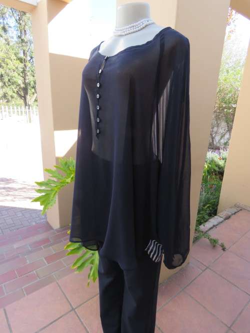 Get noticed in this sheer navy top by 'DONNA CLAIRE' in size 52/28.New condition.