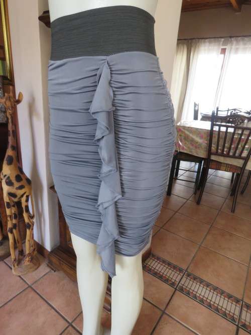 Fabulous grey ruched bodycon skirt black elastic waist.Size 30/32 in polyester stretch fabric.As new