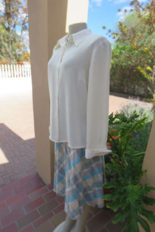 Fabulous rich cream long sleeve blouse by WOOLWORTHS in size 38/14. With cord decoration. As new.