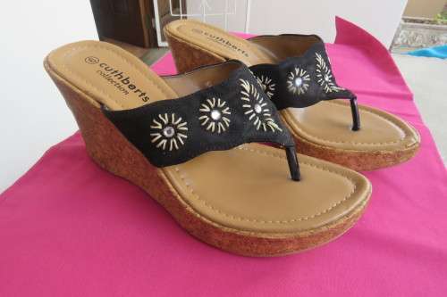 Pair of wedge heel sandals.Slip on style. Black band with embroidery and stones. Cork heels, Size 6