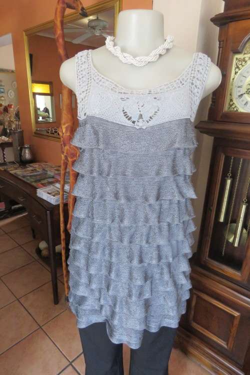 Grey Fully Frilled long top.Sleeveless with light grey lace neckline. Size 36/12. As new