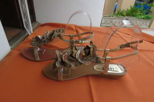 Pair Flat 'Legit' gold sandals with ankle straps. Size 4. Ankle strap. Fabric Flowers on Feet.