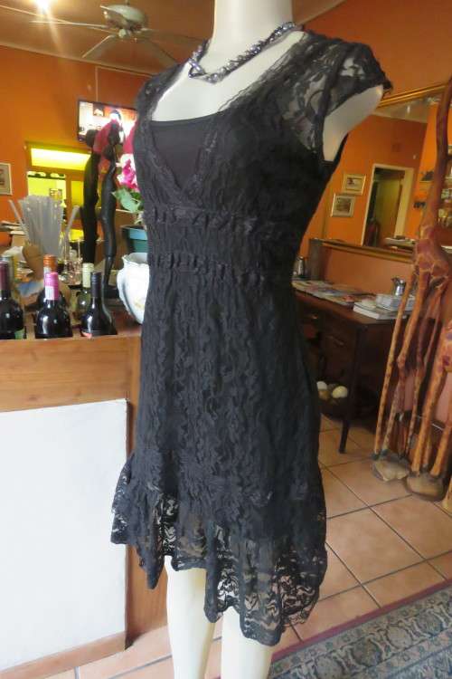 Smart black acrylic lace dress with low V neckline. Wide elasticated waist. Size 30/6.