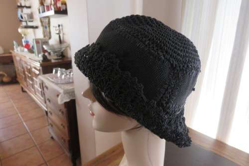Black synthetic hat with brim in as new condition. Size Medium.