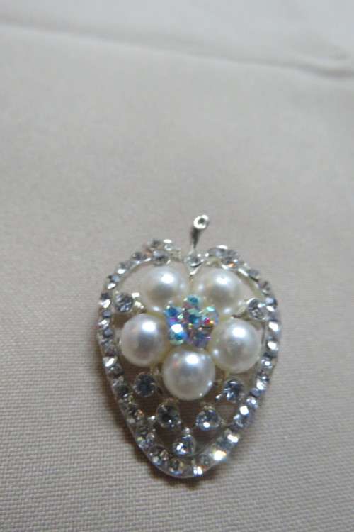 Heart shaped brooch in silver tone with Faux pearls and stones. New.