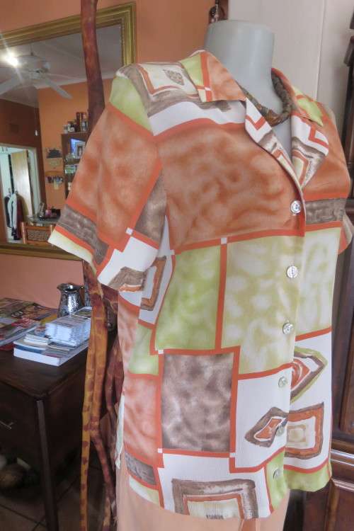 Charming short sleeve top by `Foshini` in size 36/12. In apple green, brick and white colour blocks.