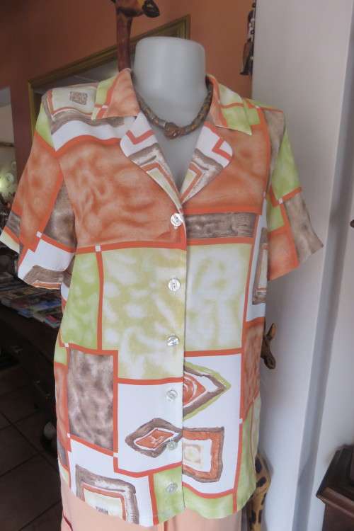 Charming short sleeve top by `Foshini` in size 36/12. In apple green, brick and white colour blocks.