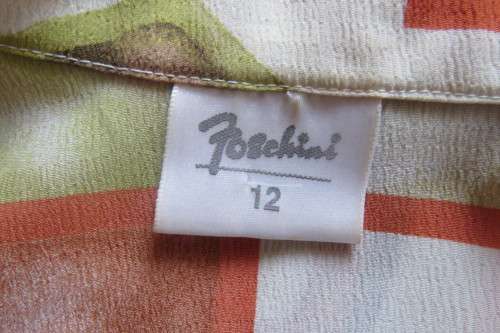 Charming short sleeve top by `Foshini` in size 36/12. In apple green, brick and white colour blocks.