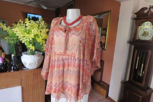 Stunning cream sleeveless polyester top with overlay in zig-zag autumn colours. Size 40/16.