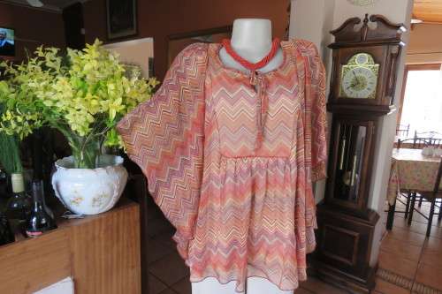 Stunning cream sleeveless polyester top with overlay in zig-zag autumn colours. Size 40/16.