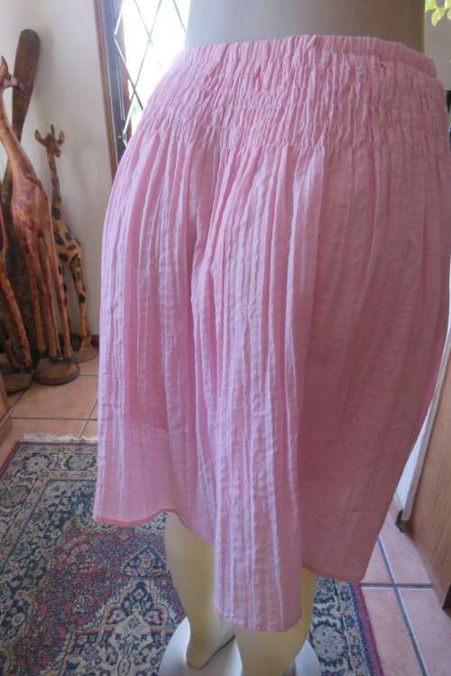 Cute carnation pink crinkled knee length skirt. Size 34/10. Smocked yoke. Elasticated waist.As new