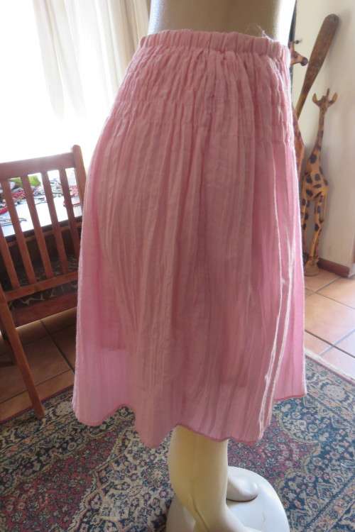 Cute carnation pink crinkled knee length skirt. Size 34/10. Smocked yoke. Elasticated waist.As new