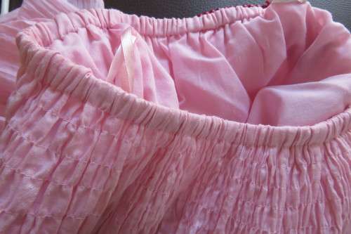 Cute carnation pink crinkled knee length skirt. Size 34/10. Smocked yoke. Elasticated waist.As new