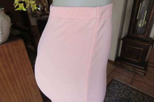 Salmon pink bodycon skirt in textured stretch polyester fabric, by 'Judy's Pride'. Size 30/6.