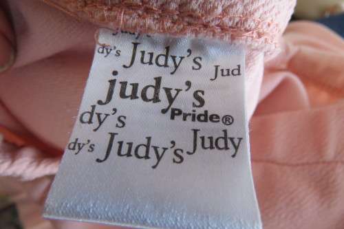 Salmon pink bodycon skirt in textured stretch polyester fabric, by 'Judy's Pride'. Size 30/6.