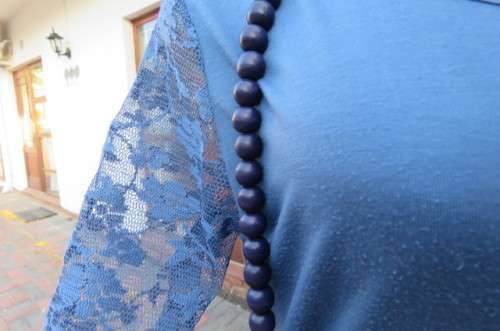Beautiful steel blue top with scooped neckline. Bracelet length lace sleeves size 34/10 by `Tango`