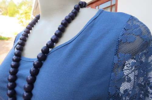 Beautiful steel blue top with scooped neckline. Bracelet length lace sleeves size 34/10 by `Tango`
