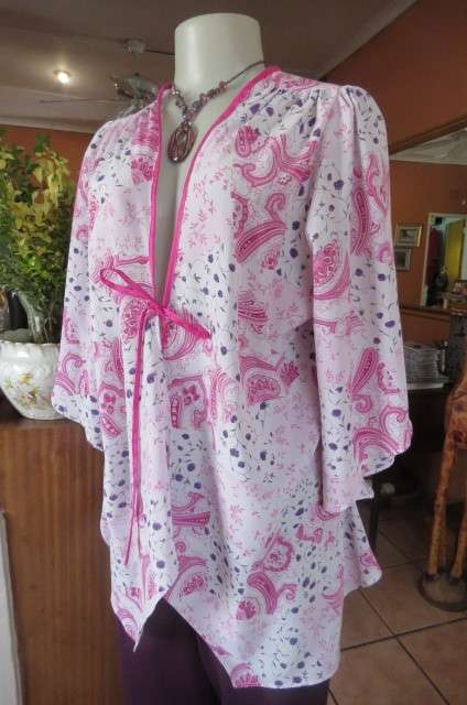 Open hanging pale lilac top with violet and dark purple paisley and floral patterns size 42/18.