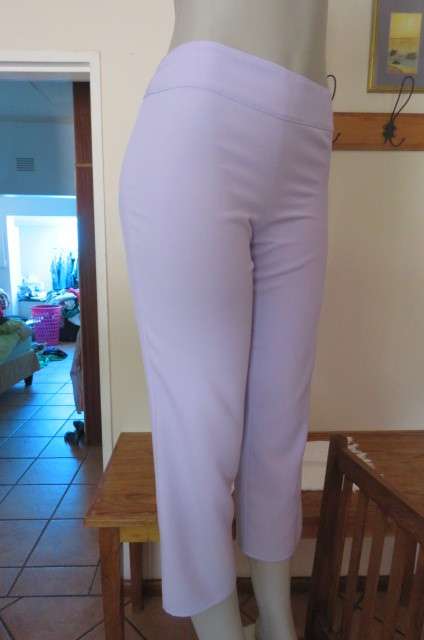 Stylish lilac ankle length pants in size 32/8 with zip at side. Wide waist band. No pockets. As new