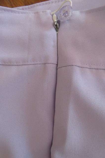 Stylish lilac ankle length pants in size 32/8 with zip at side. Wide waist band. No pockets. As new