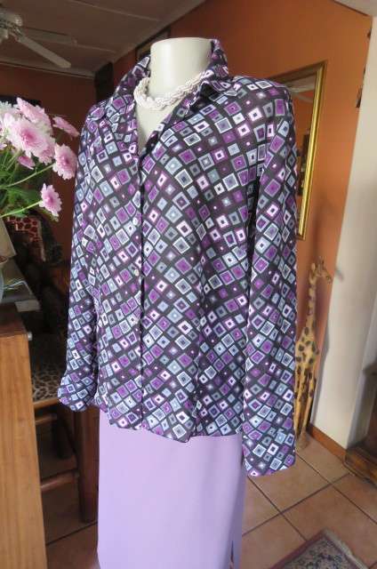 Elegant long sleeve top in black with off line purple, white and grey square blocks. Size 42/18