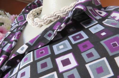 Elegant long sleeve top in black with off line purple, white and grey square blocks. Size 42/18