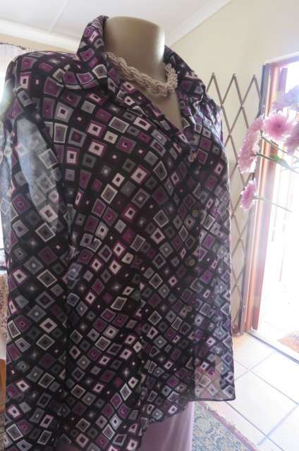 Elegant long sleeve top in black with off line purple, white and grey square blocks. Size 42/18