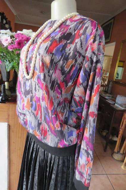 Vintage slip over long sleeve top in size 38/14. Black and white broken vertical stripes with purple