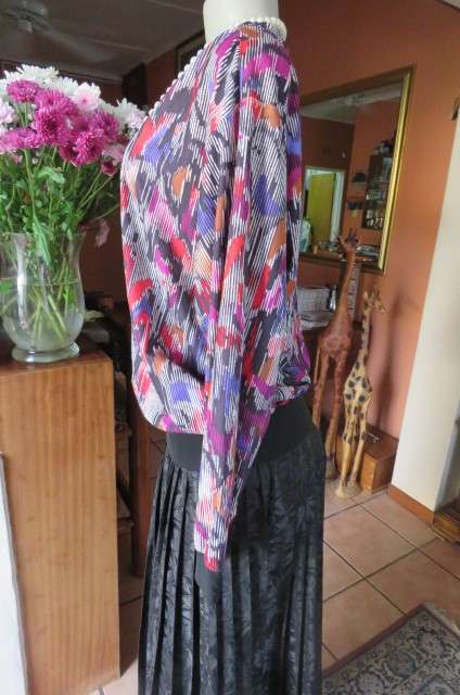 Vintage slip over long sleeve top in size 38/14. Black and white broken vertical stripes with purple