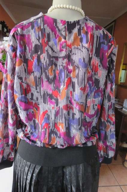 Vintage slip over long sleeve top in size 38/14. Black and white broken vertical stripes with purple