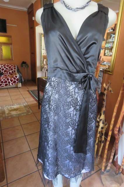 Smart black dress by Donna Claire in size 42 18. Cross over bust with ties.Satin top. bobshop .za