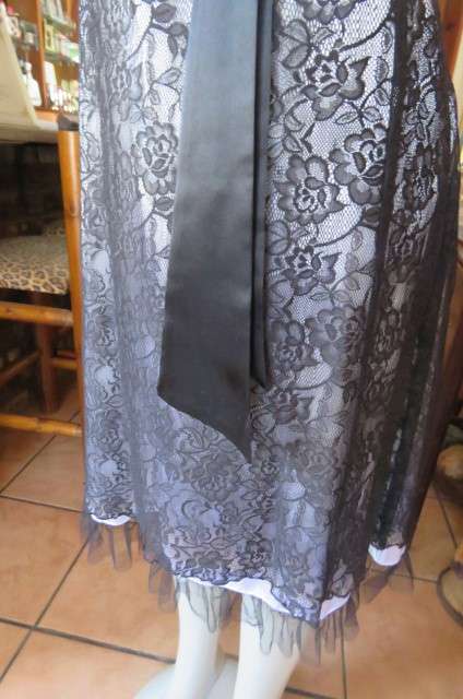 Smart black dress by 'Donna Claire' in size 42/18. Cross over bust with ties.Satin top.