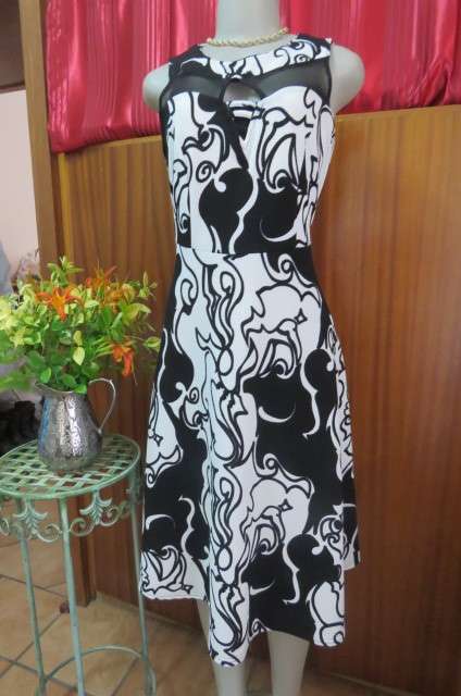 Adorable monochrome dress with sexy skin showing front detail size 37/13. Round neckline.