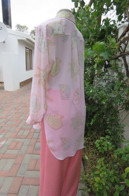 Sheer polyester long sleeve top in pale peach colour. Size 38/14 by 'Giorgio'. Cuffed sleeves.