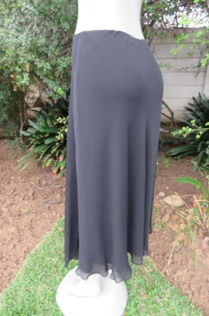 You can pair this smart black A-line skirt in 2 layers with a range of matching tops size 36/12.