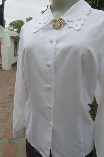 Top of the line white long sleeve top. Button down front with covered buttons size 36/12.