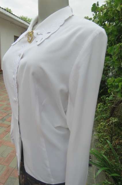 Top of the line white long sleeve top. Button down front with covered buttons size 36/12.