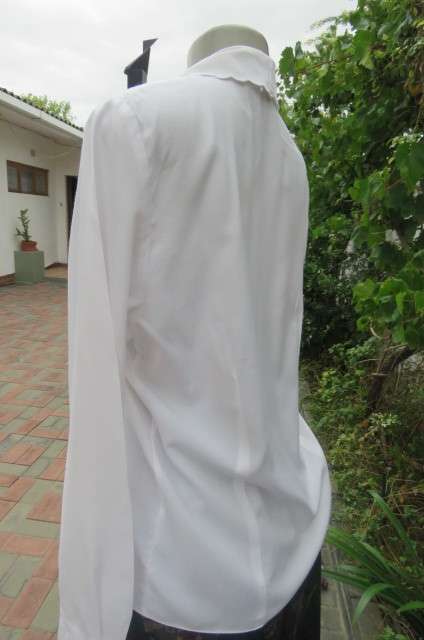 Top of the line white long sleeve top. Button down front with covered buttons size 36/12.