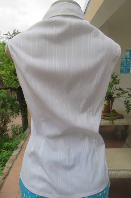 Cool white sleeveless top with front under bust gathering. Low banded V size 36/12 with collar.