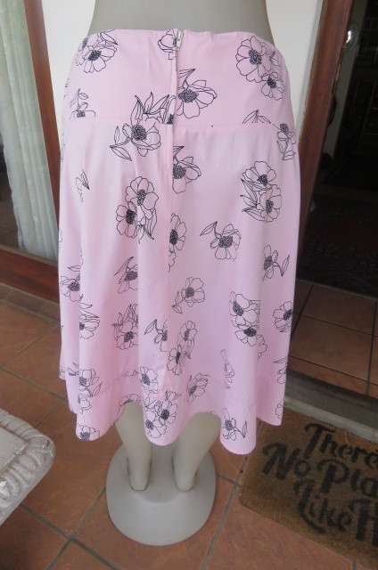 Lovely coral colour wide A-line skirt with black flowers.Yoked waist size 34/10 by `Legit`. As new.