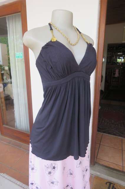 Ultra sexy black halterneck top in size 36/12. Gilded attachment on straps by 'Eringi'.
